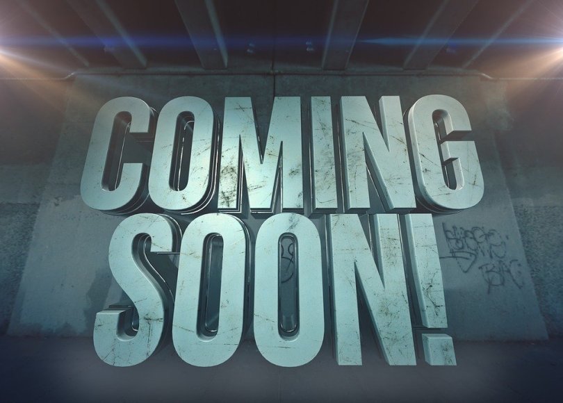 'Coming Soon' written in capital letters with spotlights on either side.