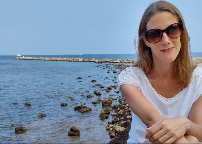 Young woman with ocean backdrop.
