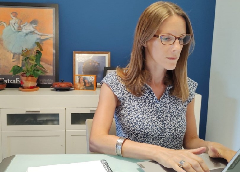 Carly sitting behind laptop screen