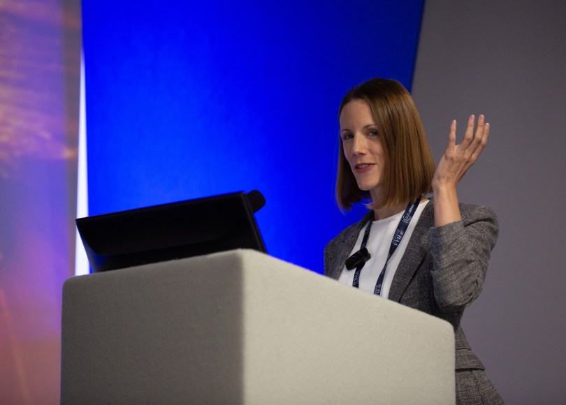 Carly stood at an alter giving a presentation