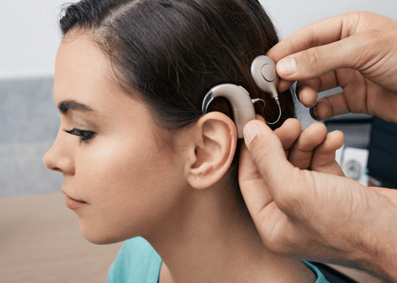 Side profile of a woman having a cochlear implant fitted.