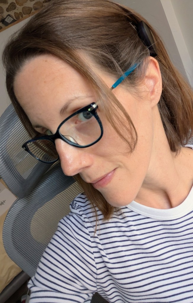 Photo of Carly wearing her glasses with her Rondo 3 processor.