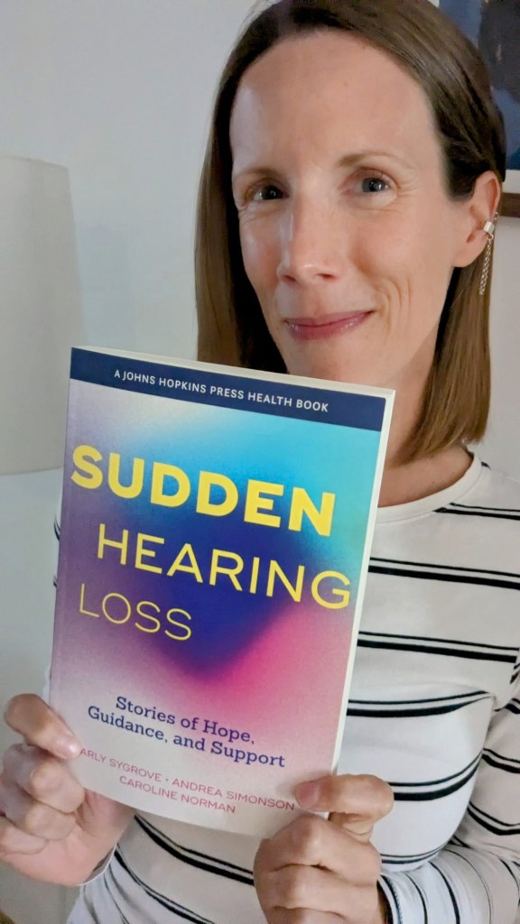 Carly opening a parcel: an advanced copy of her book